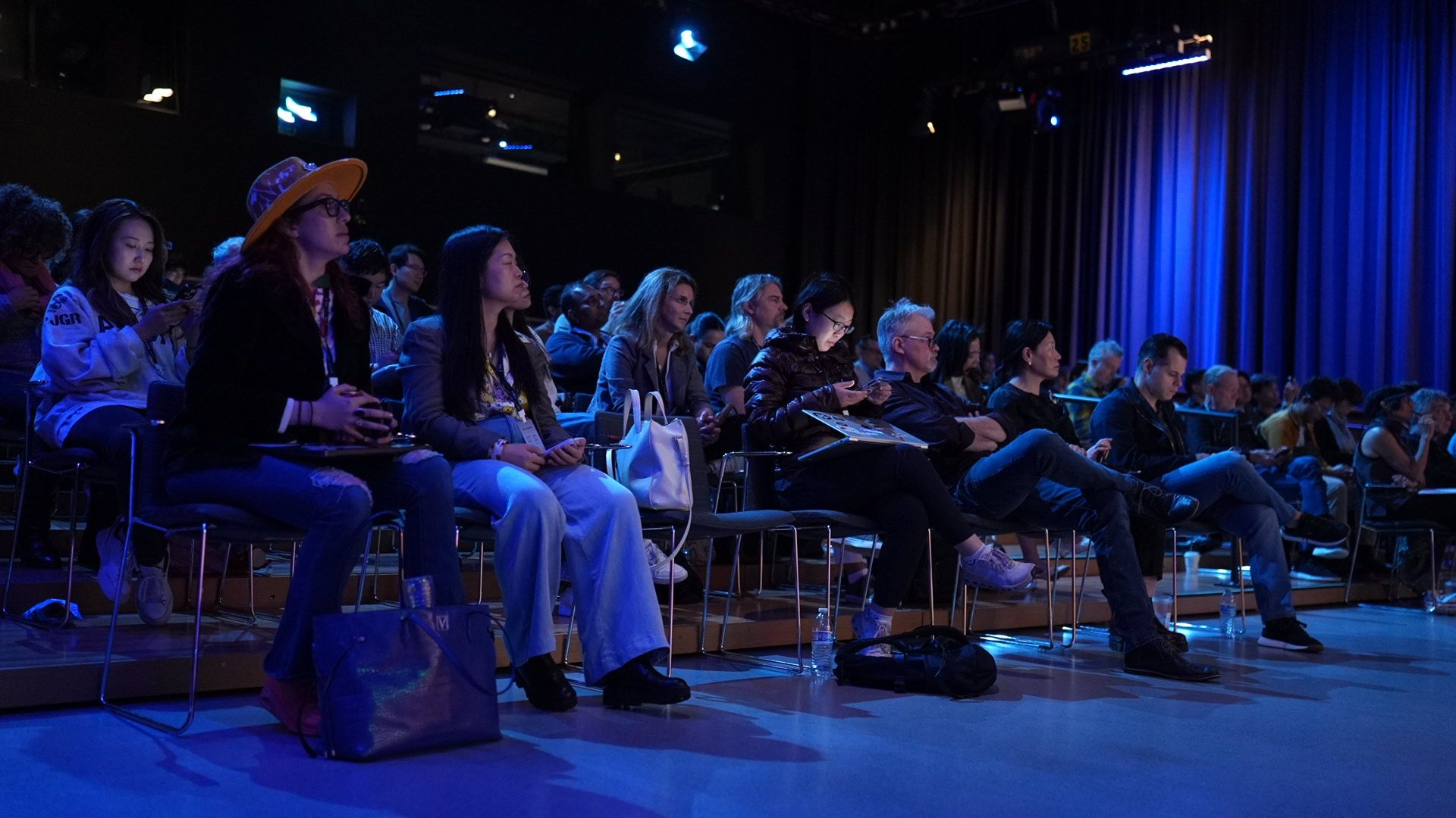 The audience listening to a session in the blue-lit theater at the Soulscape 2026 Industry Summit