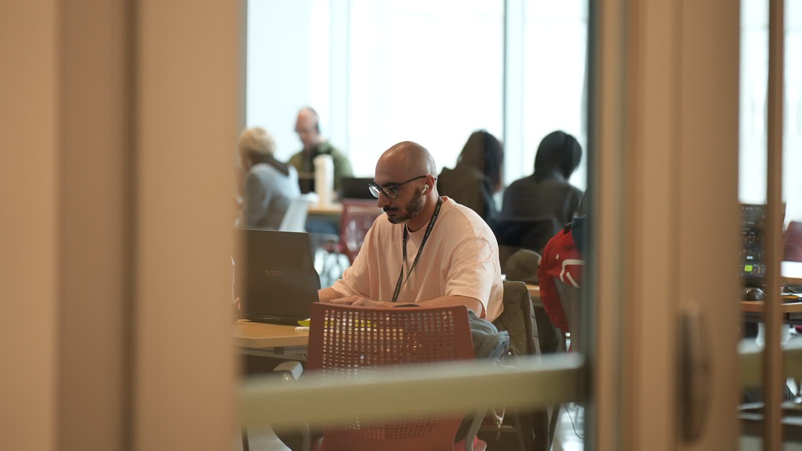 A creator at work during the 48 hours, seen through a doorway