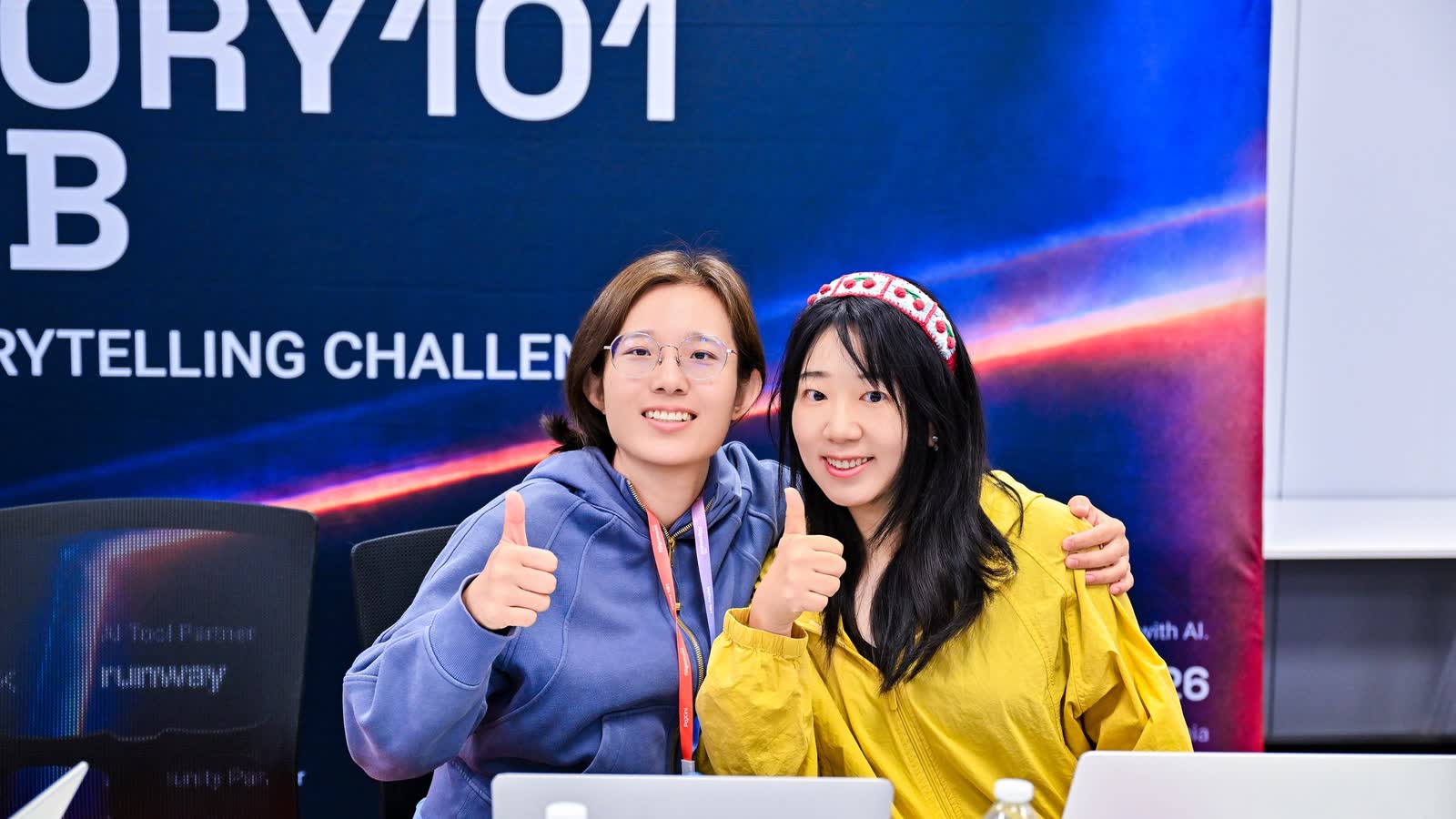 Two makers in front of the STORY101 LAB banner