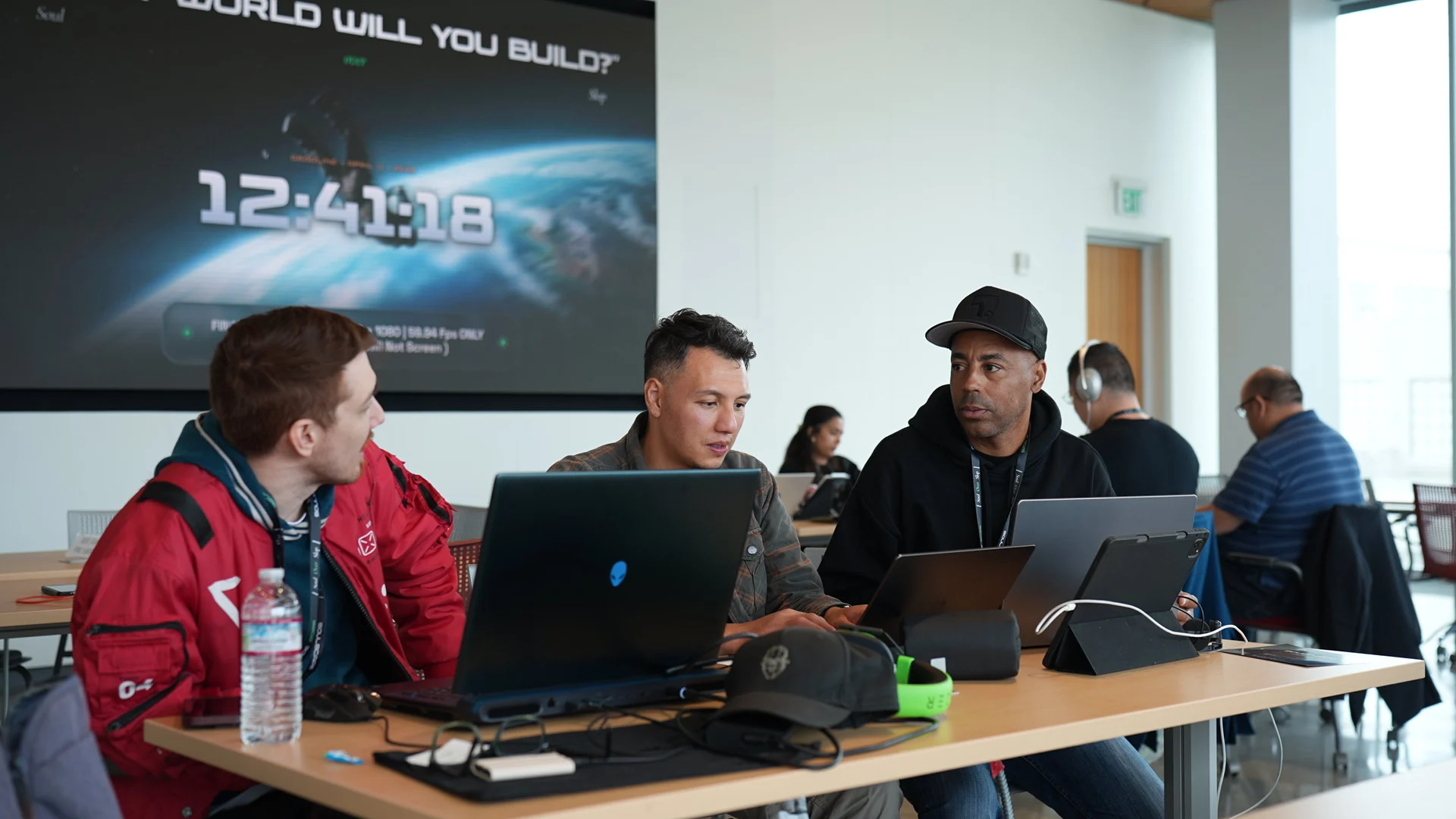 Creators collaborating around a laptop at the Soulscape 2026 Cinema Lab
